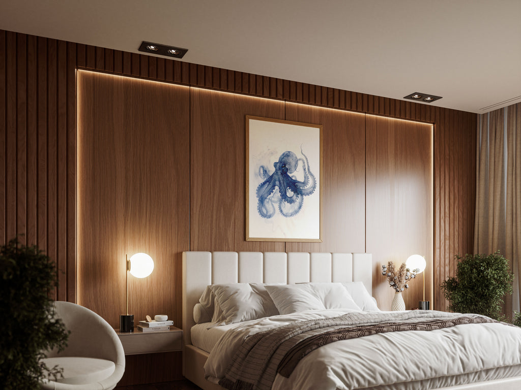 Alderluxe octopus x-ray art print framed above a modern bed with wood panel wall and soft lighting