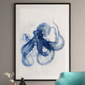 Alderluxe octopus x-ray art print in blue framed and hung on a wall above a teal chair